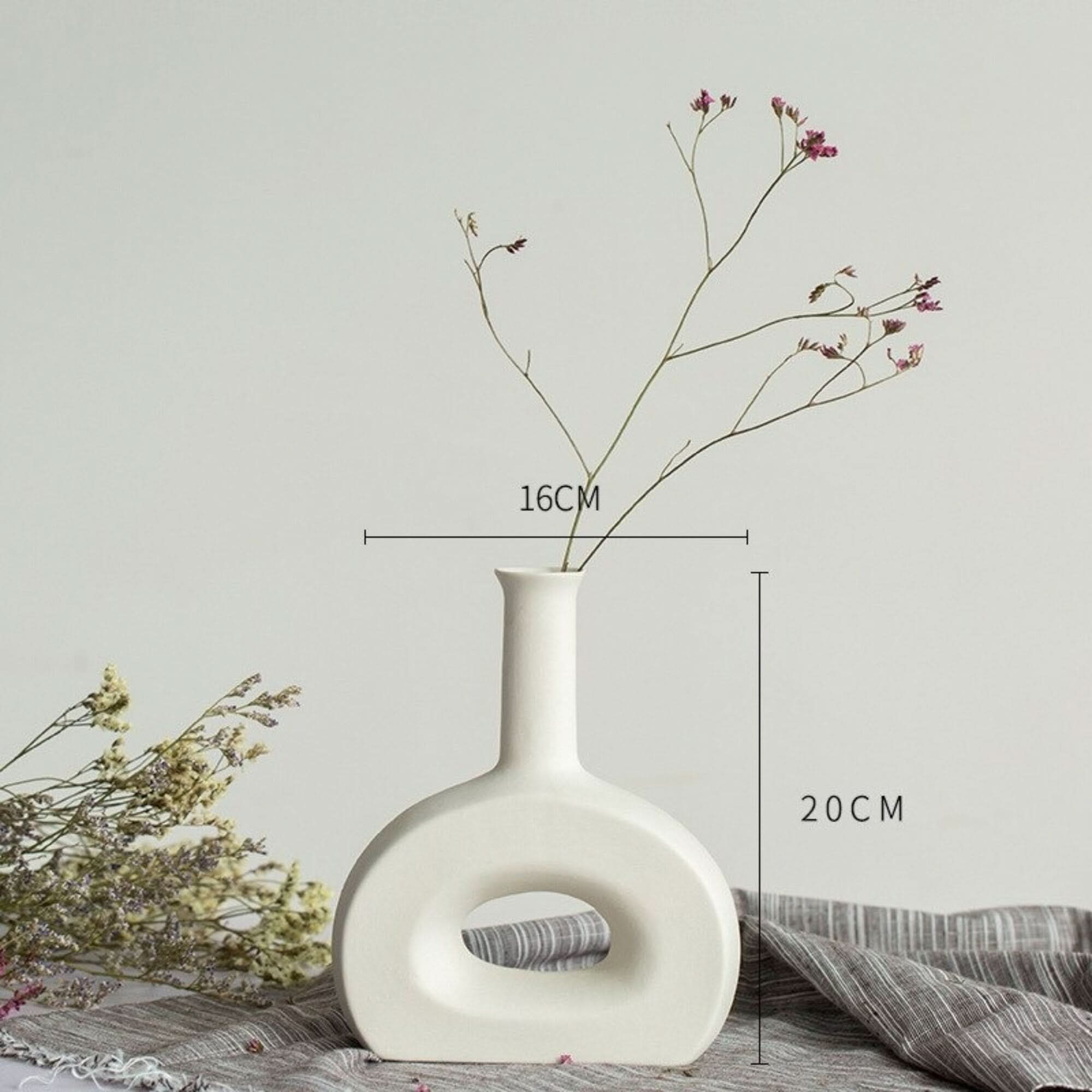 Abstract White Flower Vase with delicate dried flowers, minimalist ceramic design.