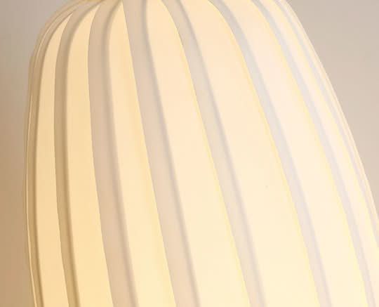 White Japandi table lamp with oval shape and ribbed texture