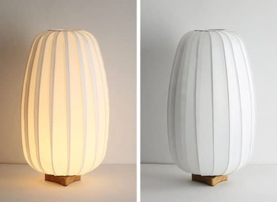 Japandi Table Lamp: Oval, ribbed white shade with wooden base.