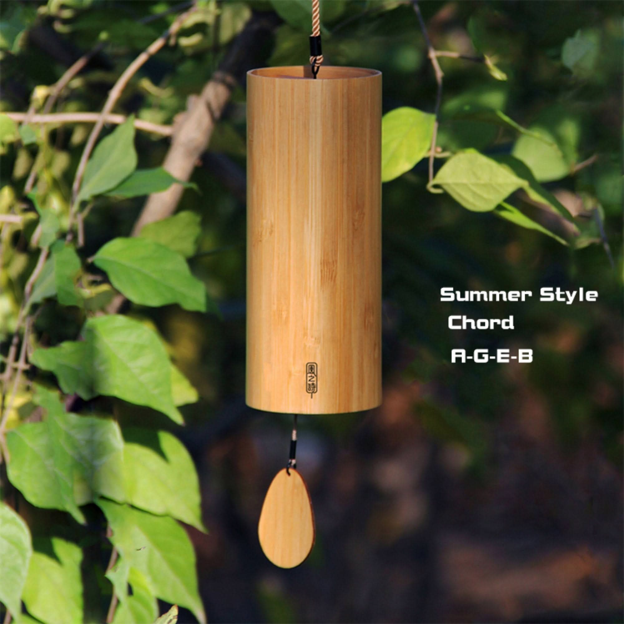 Natural bamboo wind chime with summer chord A-G-E-B hanging outdoors.