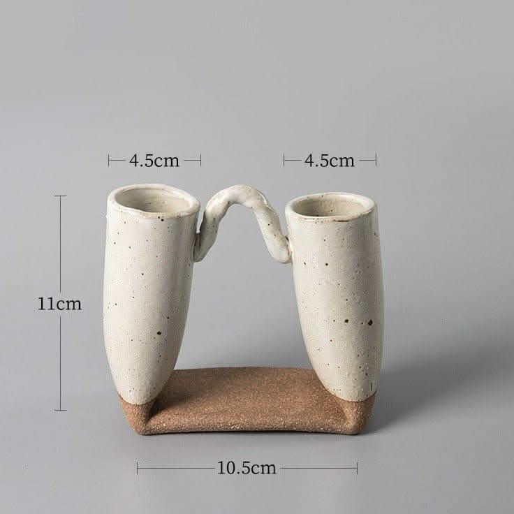 Japanese textured ceramic vase with bent tube design, beige with speckled finish