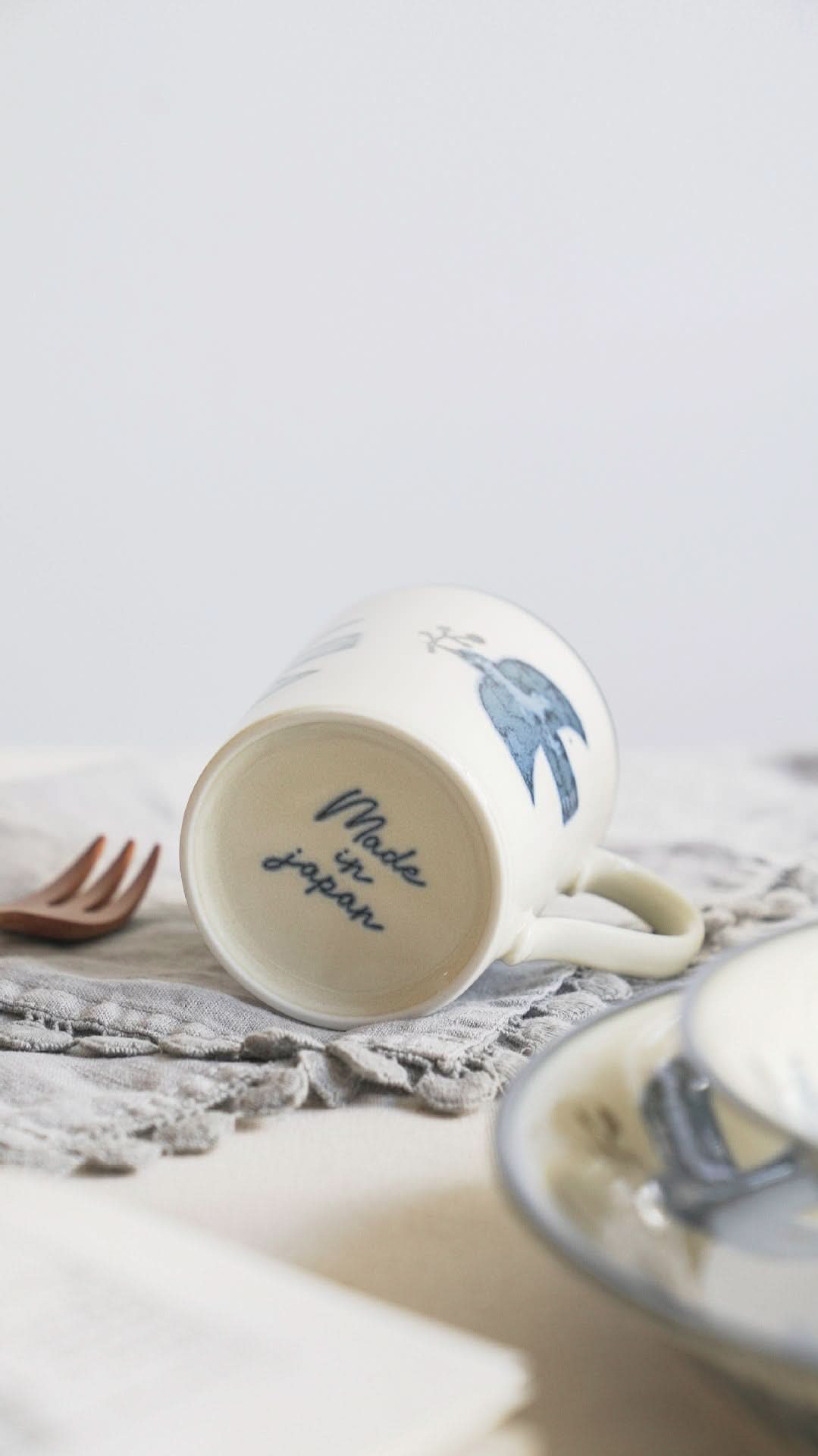 Bird Handpainted Mino Yaki Pottery Mug, white ceramic with blue bird art and "Made in Japan" stamp.