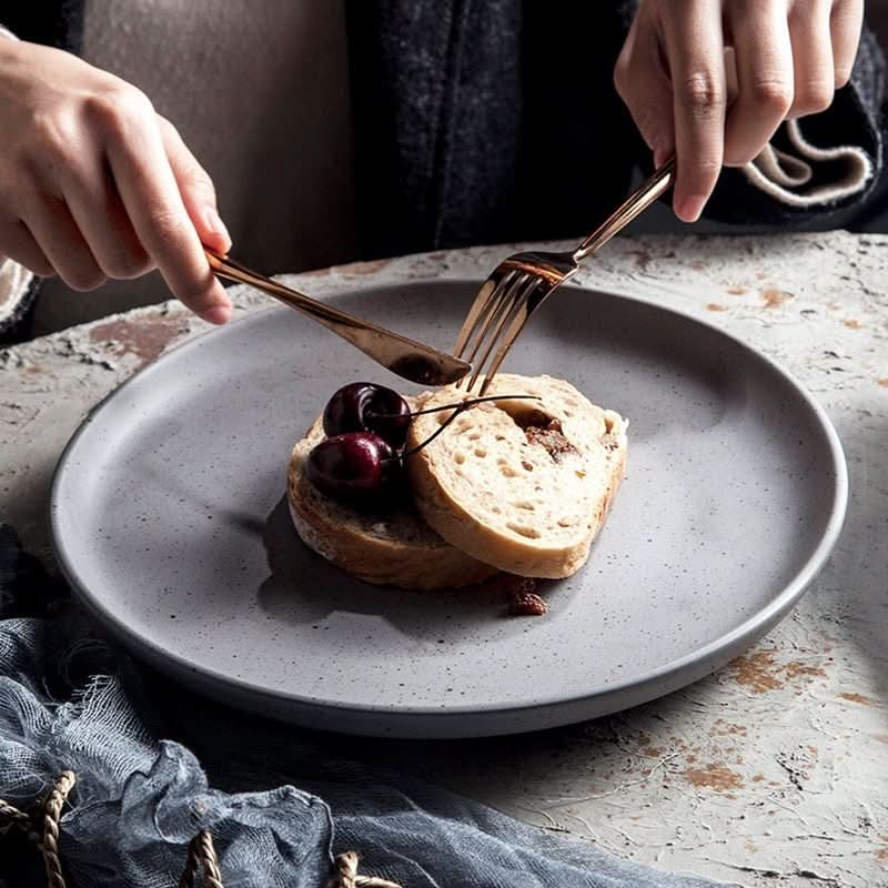Grey ceramic Nordic plate with bread and cherries. Bistro tableware for all seasons.