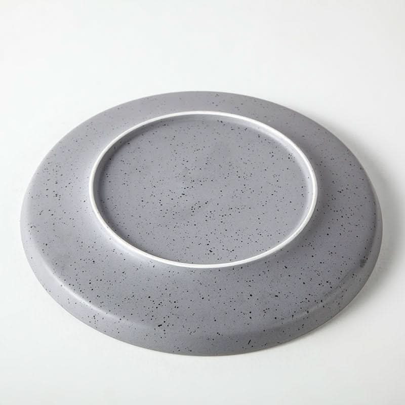 Bistro ceramic tableware grey Nordic plate with speckled finish on white background.