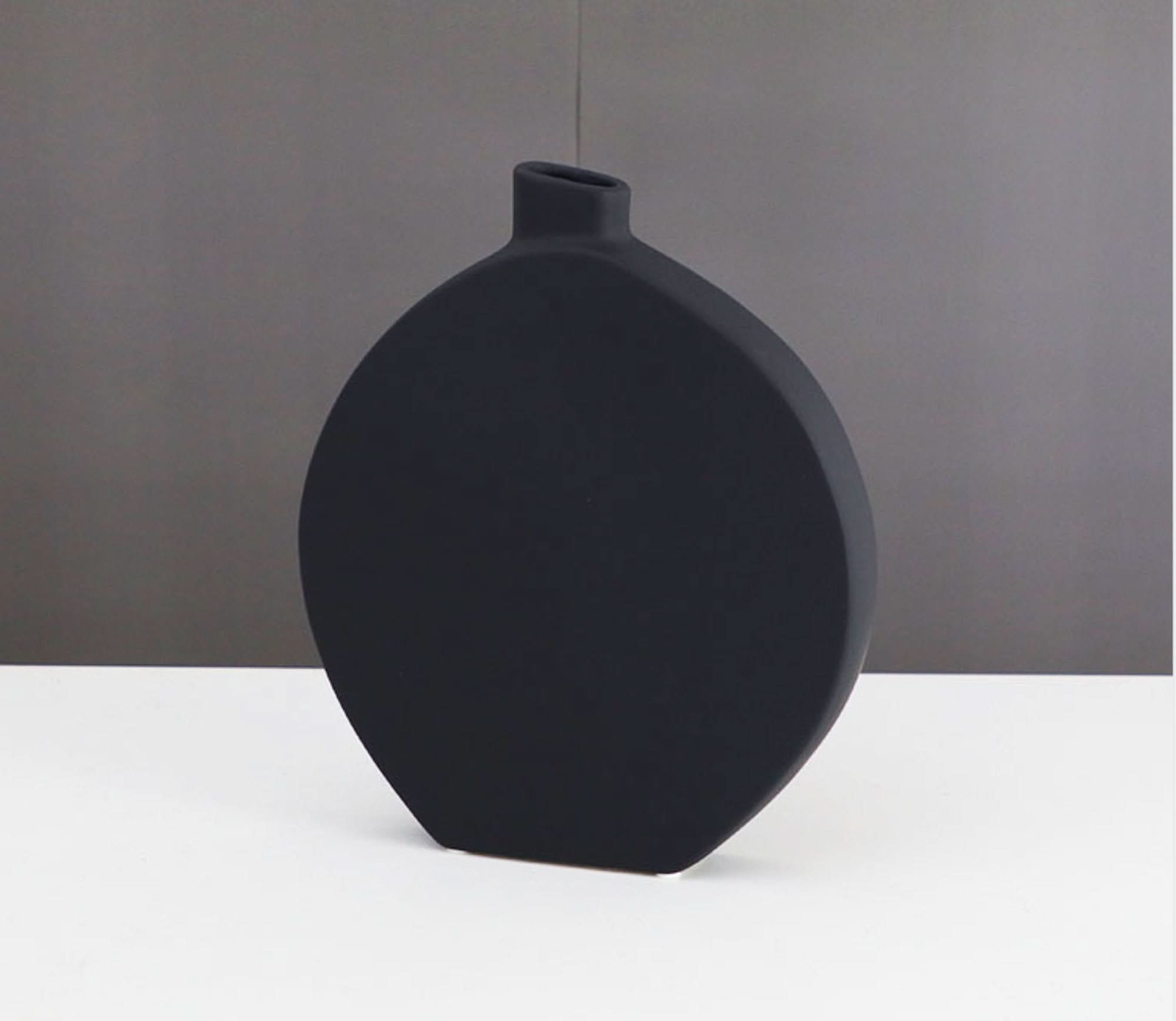 Black minimalist ceramic vase for Zen decor and table display.