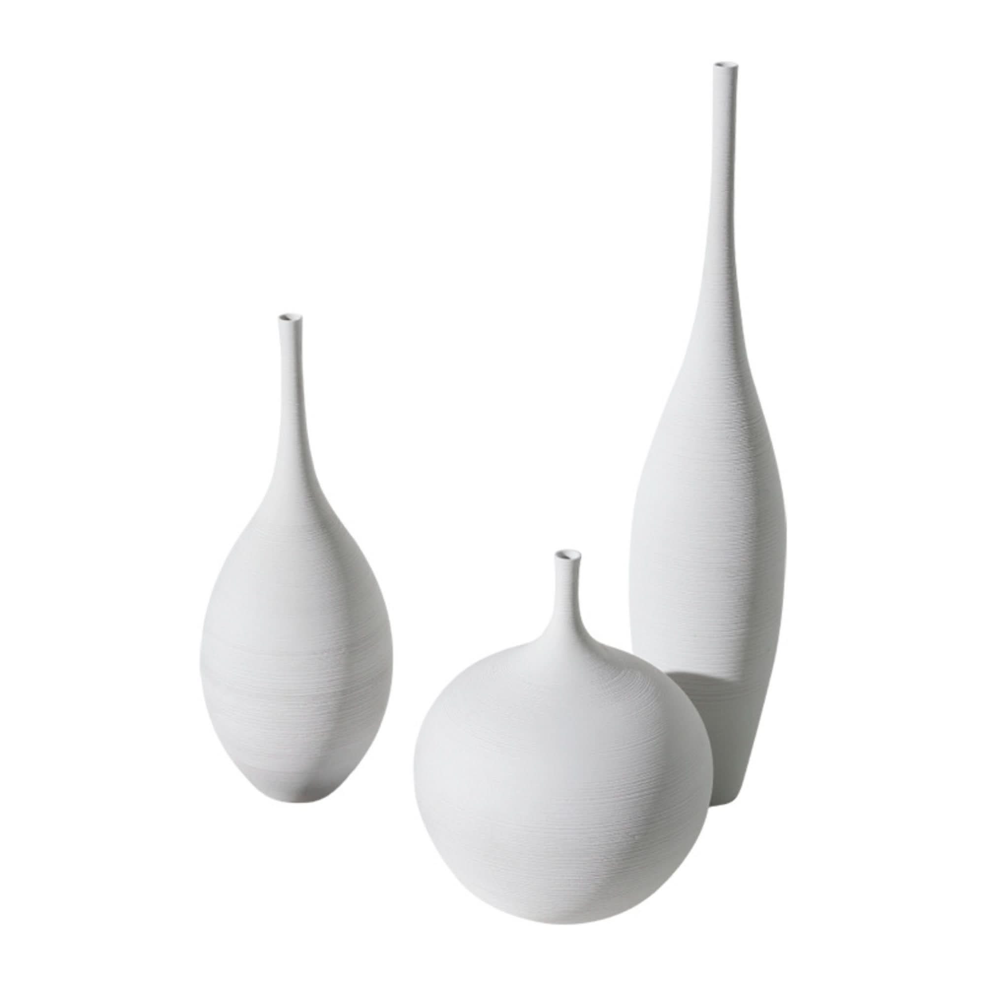 Three white ceramic minimalist vases, textured finish, home decor.