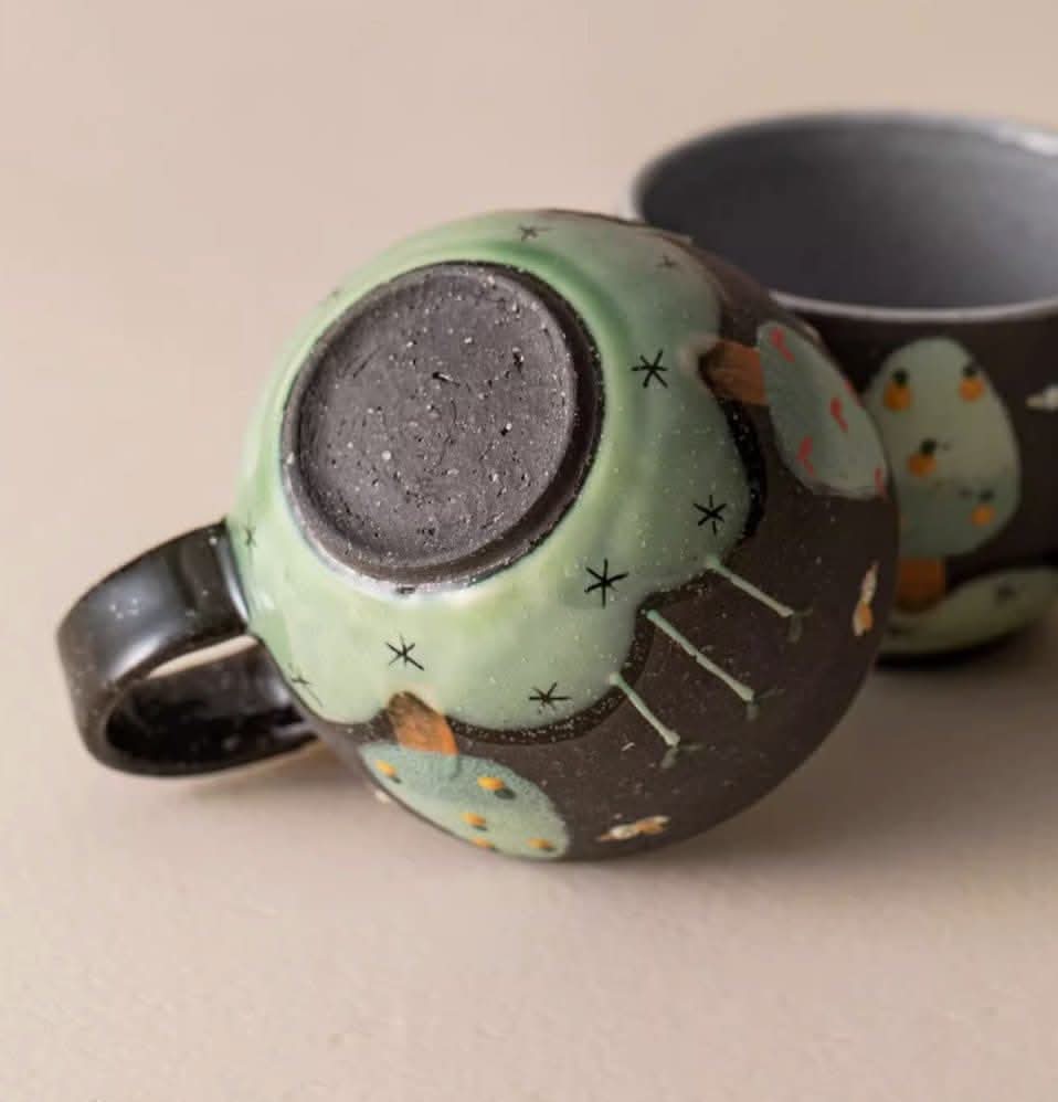 Brown Clay Underglaze Bee Mug, handmade in Japan. Features green and black glaze with whimsical bee design.