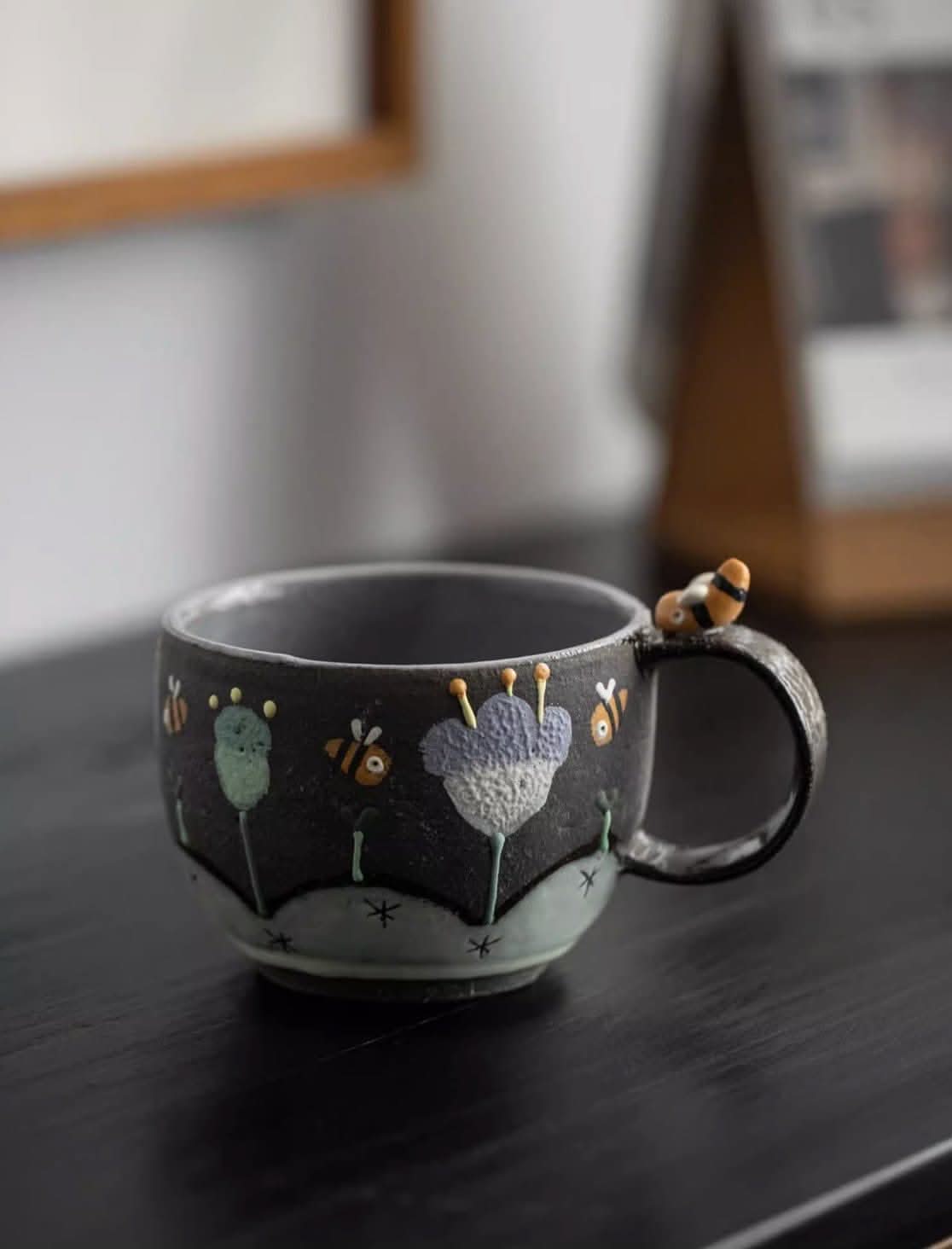Brown clay underglaze bee mug, handmade in Japan, with bee detail on handle.