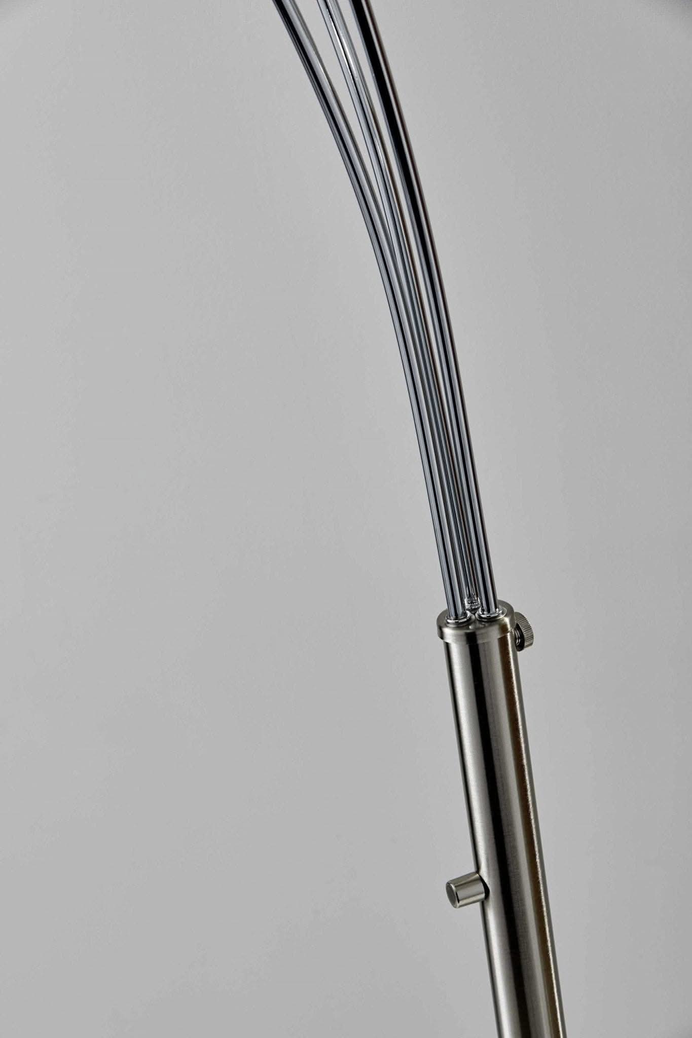 Close-up of silver metal arc lamp base and stems against light gray background.