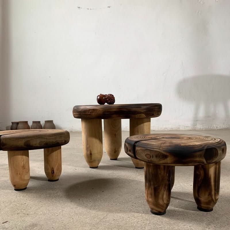 Three wood stools with charred tops and natural wood legs, home decor.