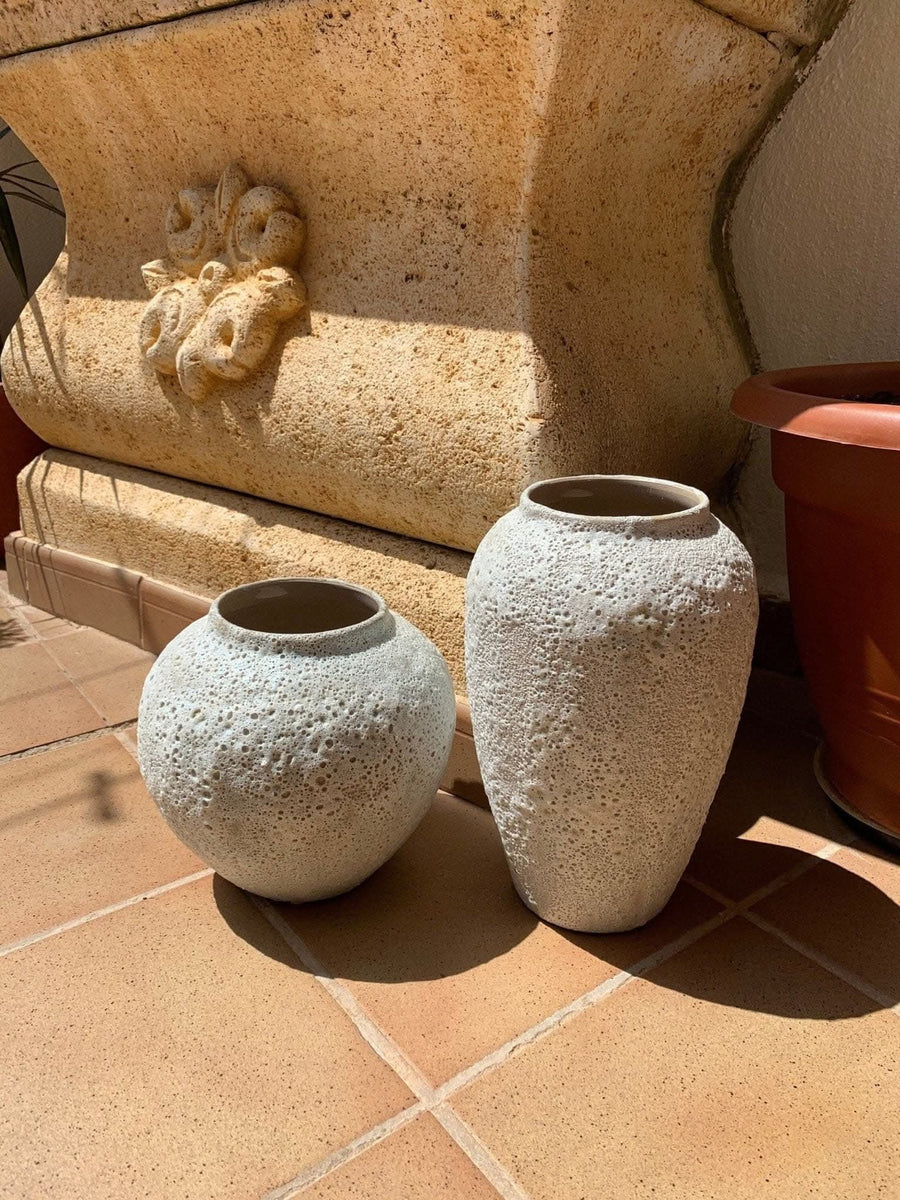 Ceramic Bubble Glaze Textured Vase in off-white, shown on terracotta tiles with a decorative stone planter.