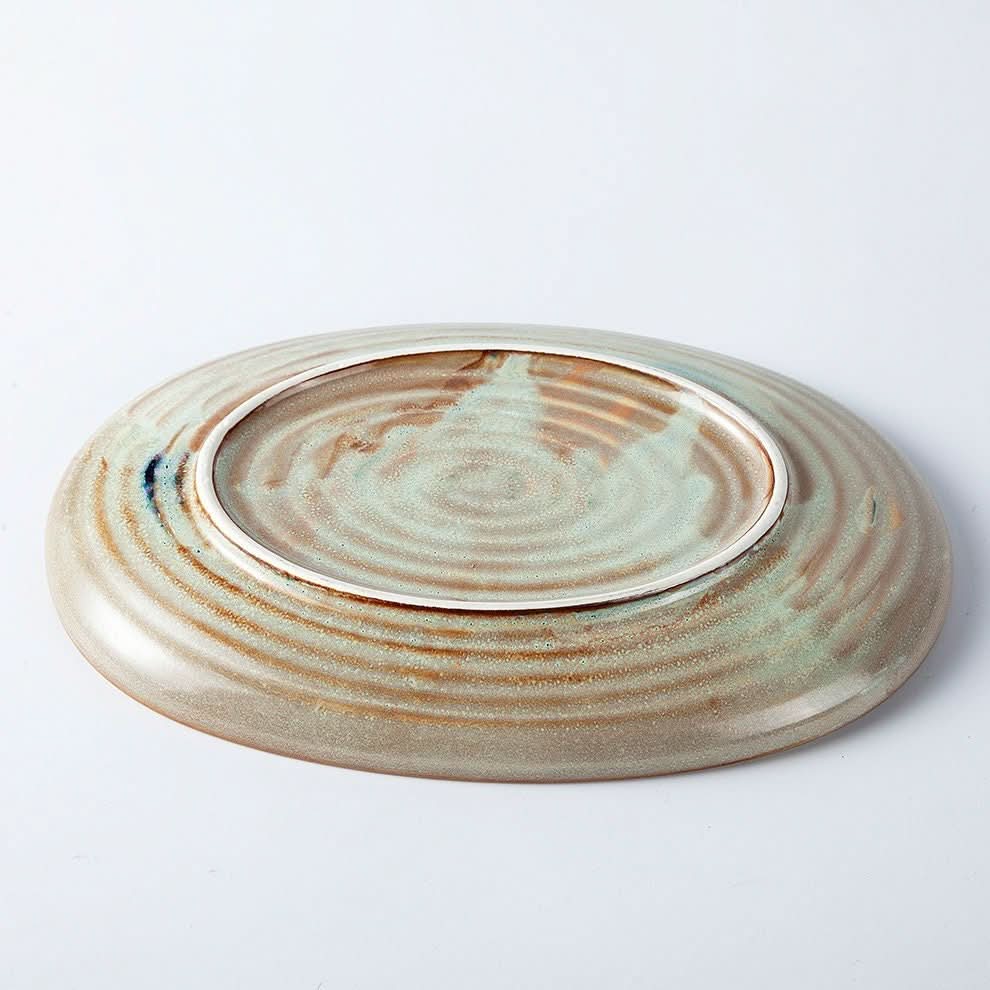 Grey stoneware oval plate with rustic Japanese diner design, Nordic style.
