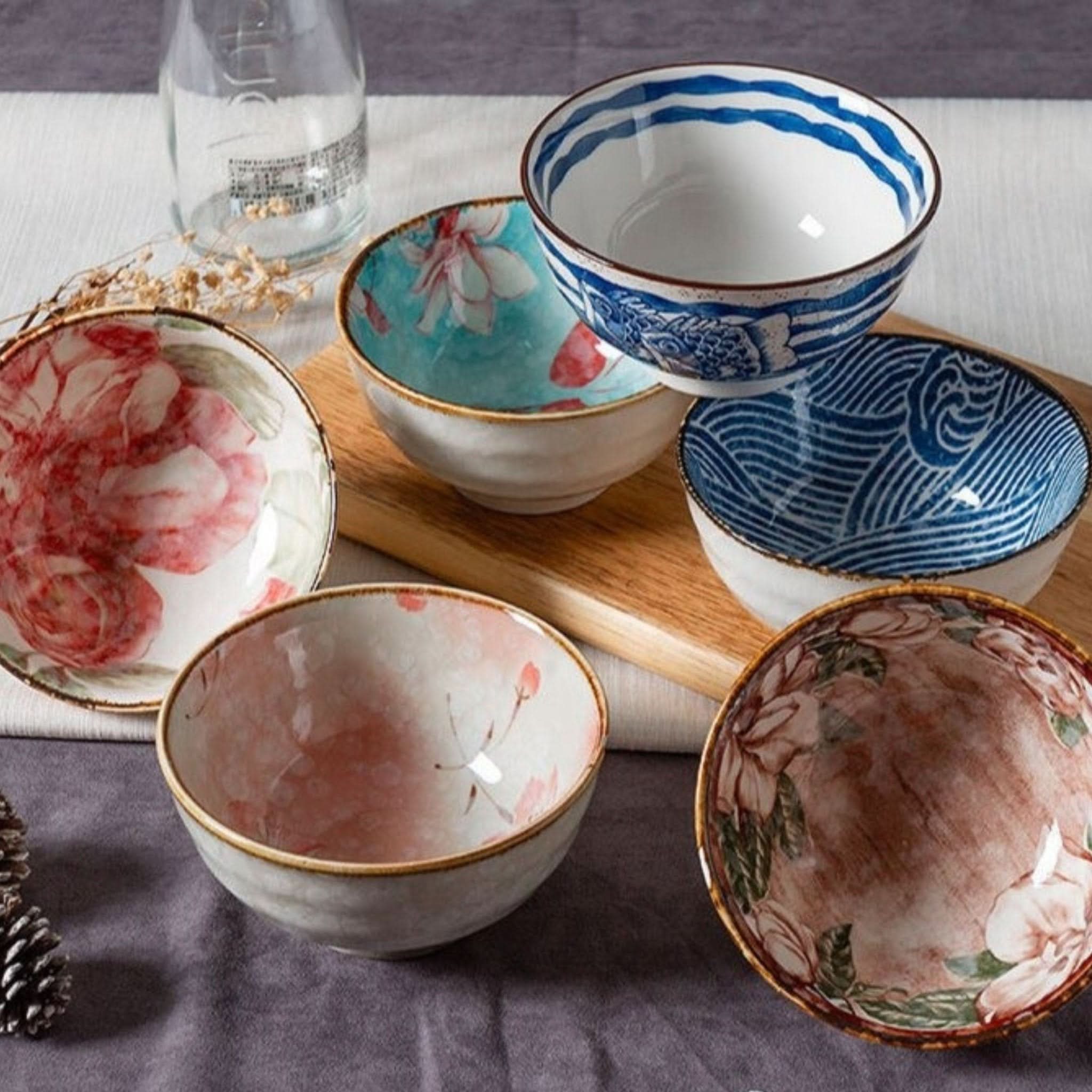 Ceramic glazed 4.5" bowls with Japanese floral illustrations, perfect for noodles or soup.