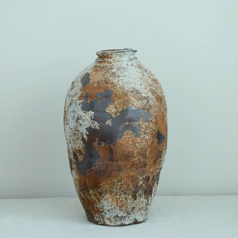 Ceramic Irregular Vase with rough, metallic texture in brown and white. Handmade stoneware jar for decor.