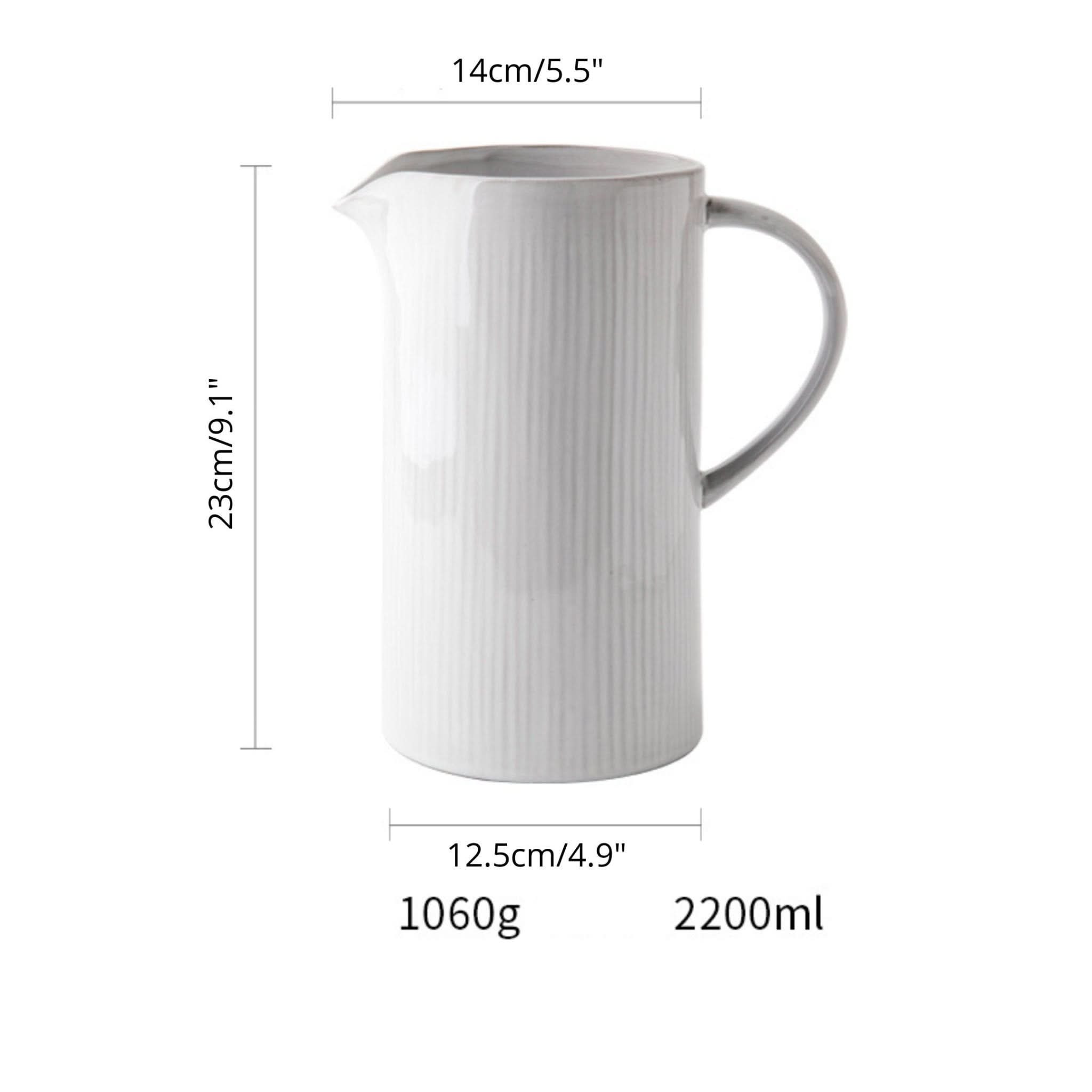 White ceramic pitcher utensil holder with farmhouse style, kitchen storage.