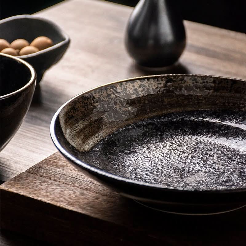Rustic black and gold Japanese Pottery Tableware 9" serving bowl on wooden surface.