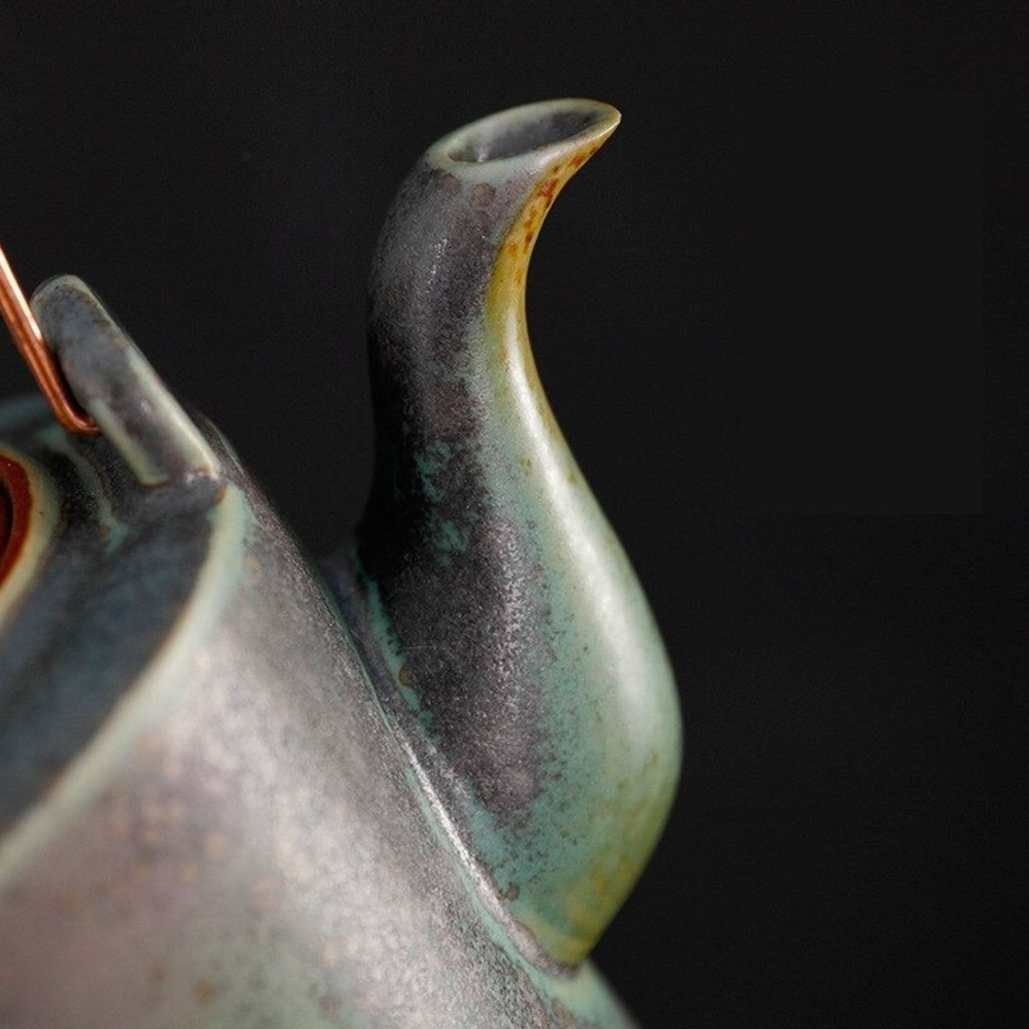 Ceramic tea pot with Japanese crane design, green and black glaze, copper handle