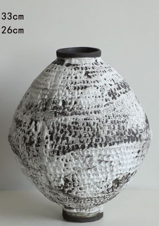 Ceramic vase with hammered circular texture and brushed effect in black and white home decor.