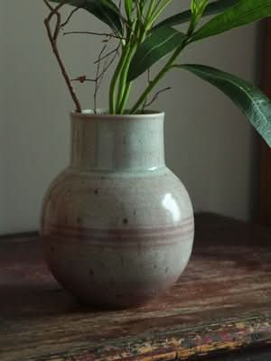 Clay Handmade Large Vase, rounded, neutral tones, with plants, on rustic wood table.