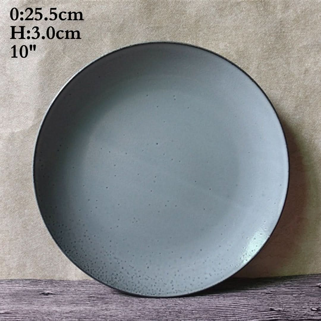 Cyan Blue Glazed Ceramic Dinnerware Set with Speckles, a 10" dinner plate on a wooden surface.