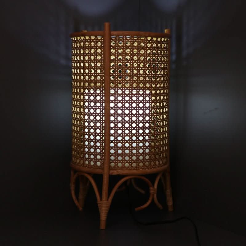 Cylindric Rattan Table Lampshade with 3 Legs, handwoven, natural fiber, warmly lit.