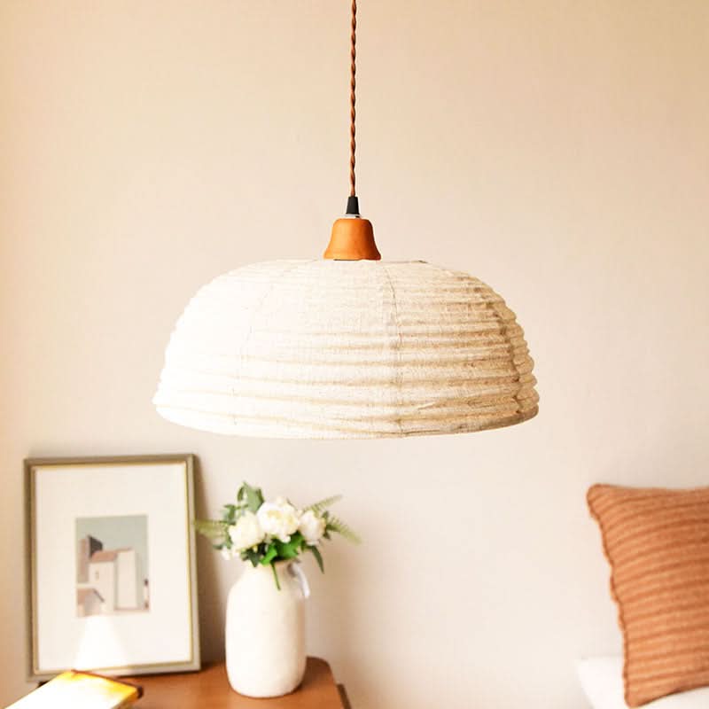 Dome lampshade with textured hemp fabric and terracotta top, part of home decor collection.