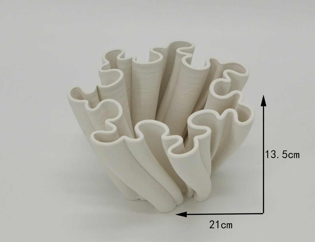 A 3D printed ceramic planter in a light beige color. The planter has a unique, organic, fractal-like design.