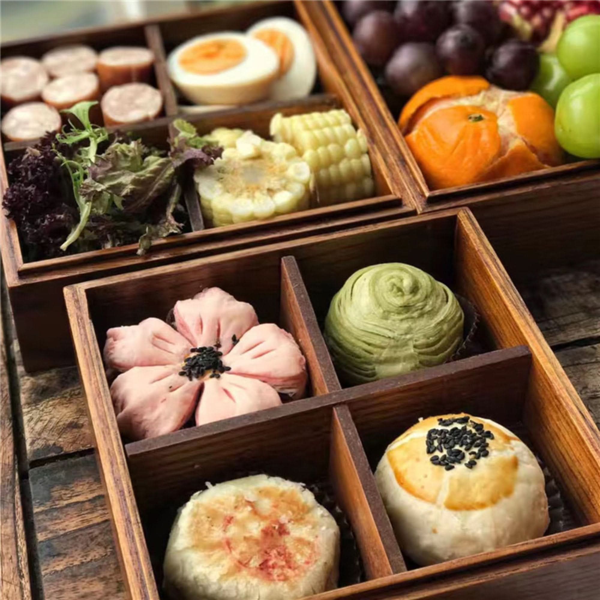 Japanese Bento Box 6.5"x2.5", 3pcs: wooden box filled with food like fruit, eggs, and pastries.