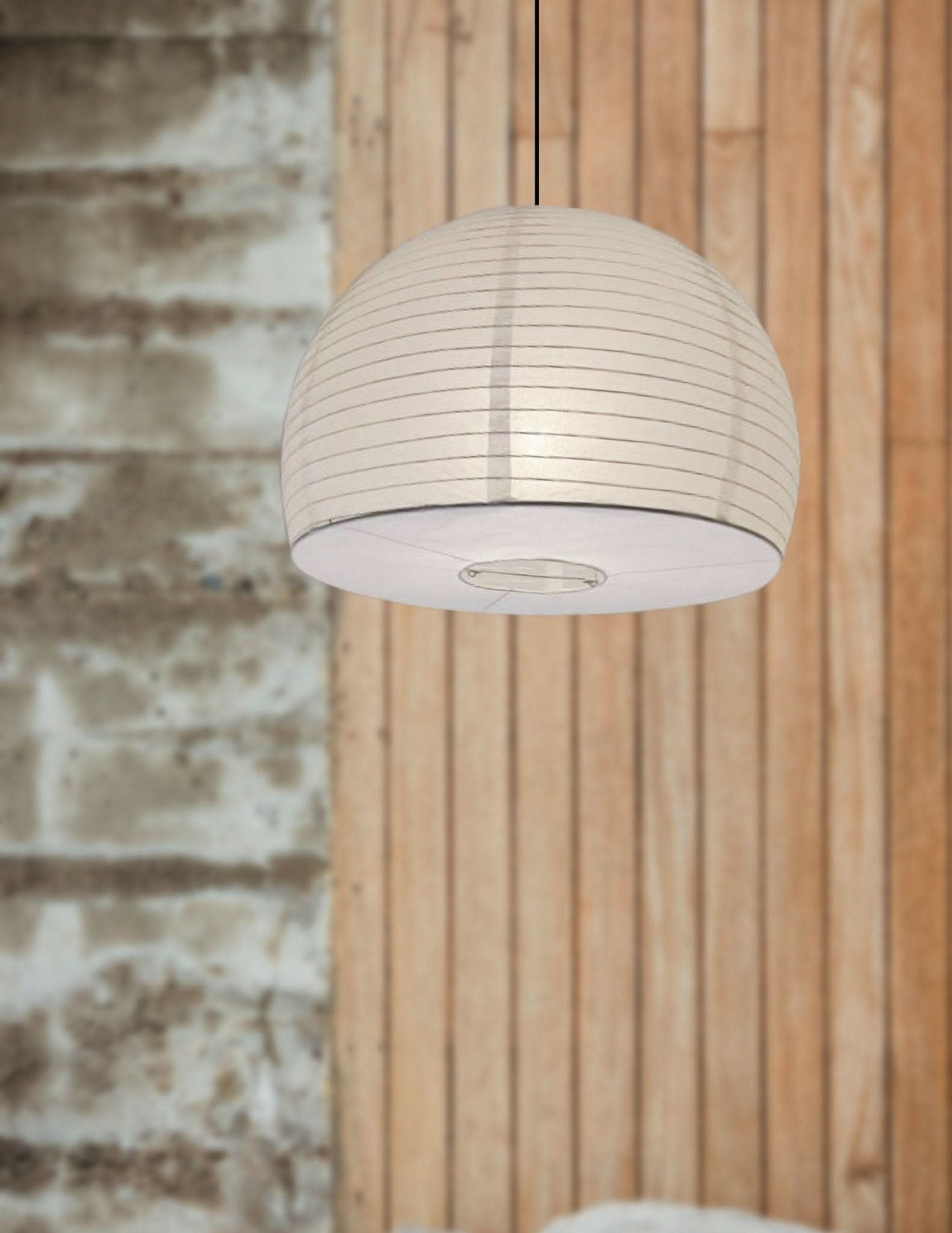Cream dome paper ceiling lampshade with horizontal lines, hanging against wood paneling.