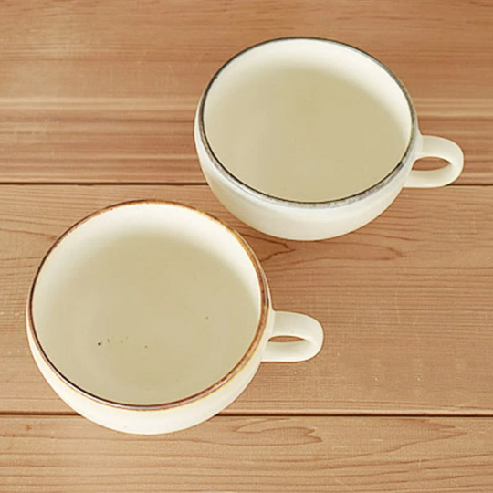 Japan Imported Minoyaki single handle white ceramic bowl cups on wood.
