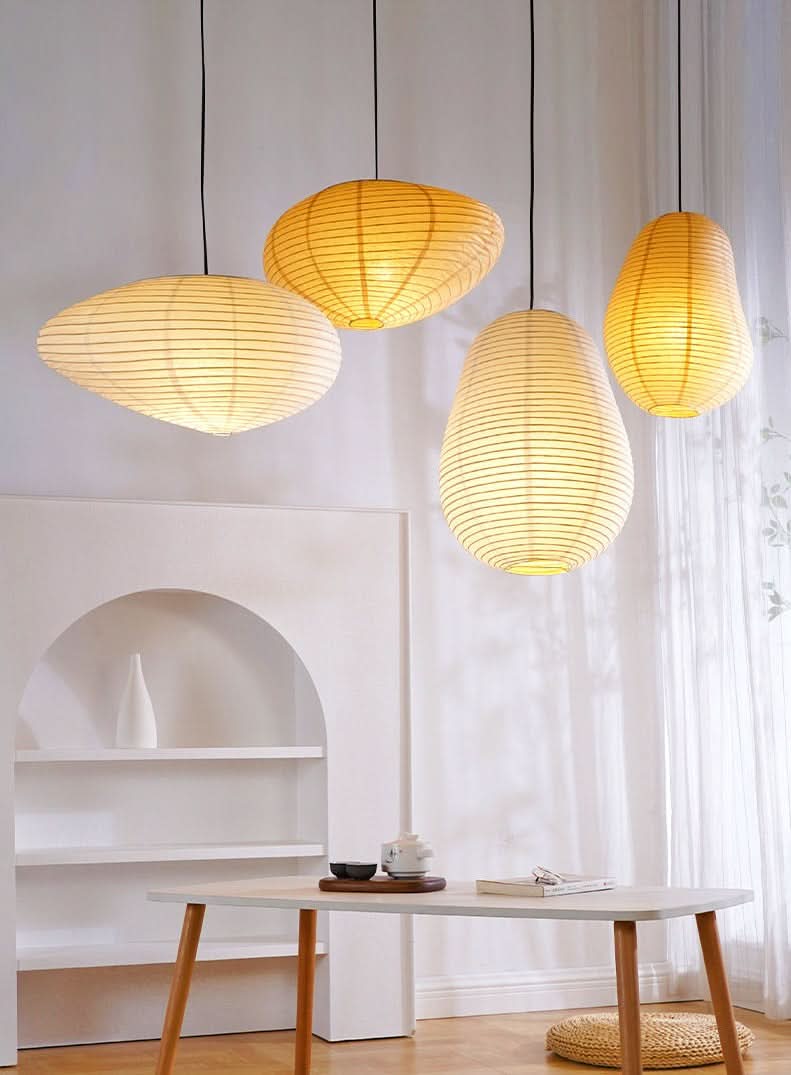 Warm yellow paper lampshades, irregular shape, hanging in a modern home decor setting.
