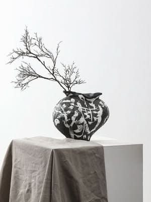 Handmade Wabi Sabi ceramic flower ware, black & white, with dried branches, living room decor.