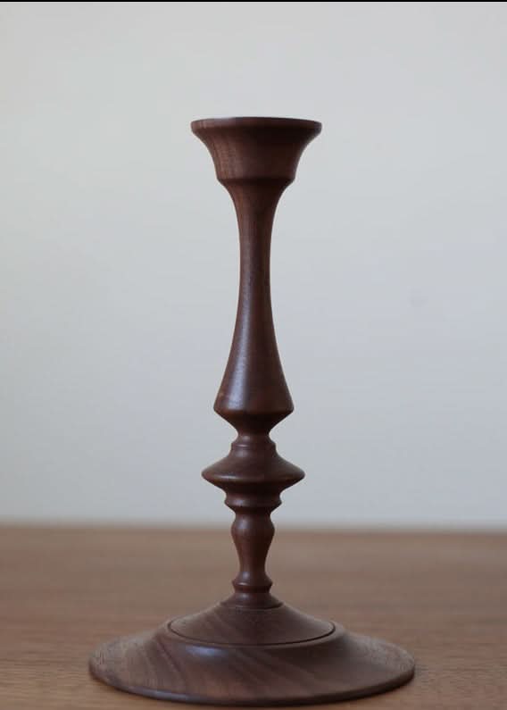 Walnut wood pillar candle holder on wood surface
