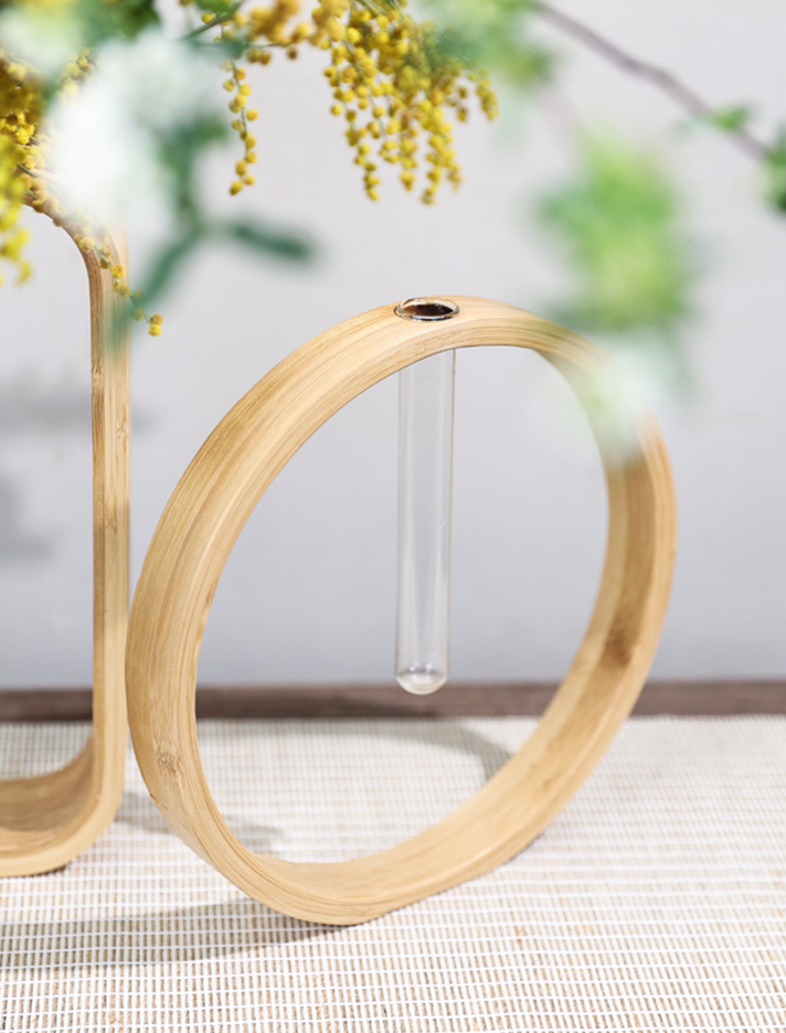 Natural bamboo wall flower vase with glass test tube, minimalist home decor.