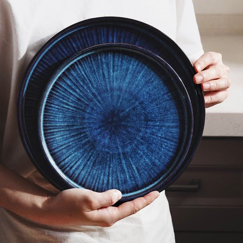 Deep blue, kiln-glazed ceramic plates with radial pattern. Flat Ceramic Glazed Plates.