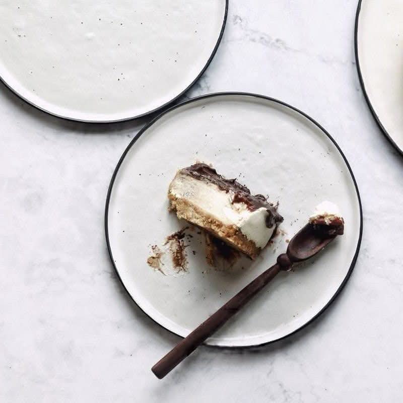 Flat Stoneware Speckled Plate with chocolate cake slice and dark wood spoon.