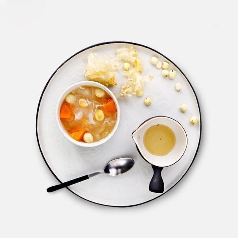 Flat Stoneware Speckled Plate with soup and sauce.