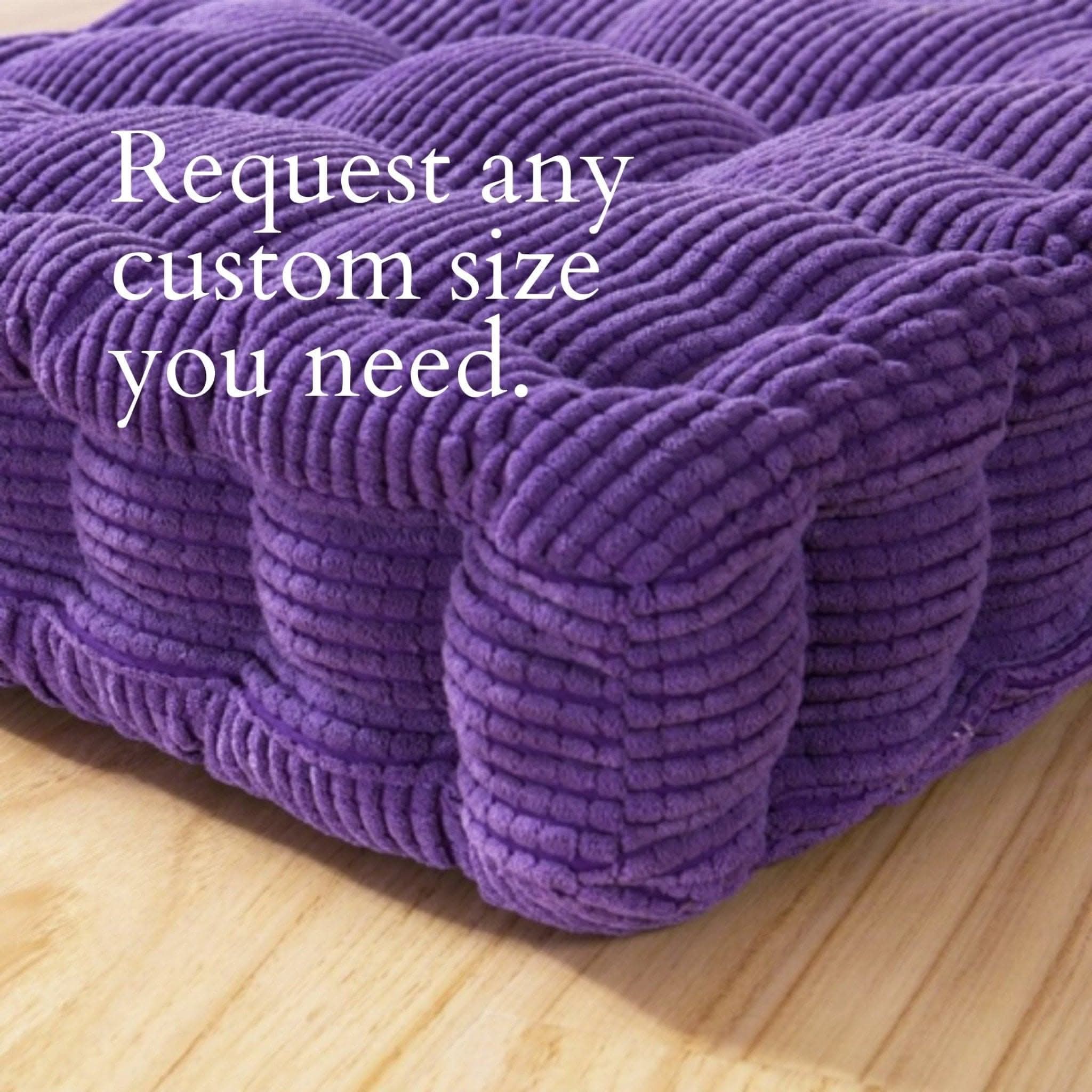 Plush purple custom window seat cushion on a wooden floor.