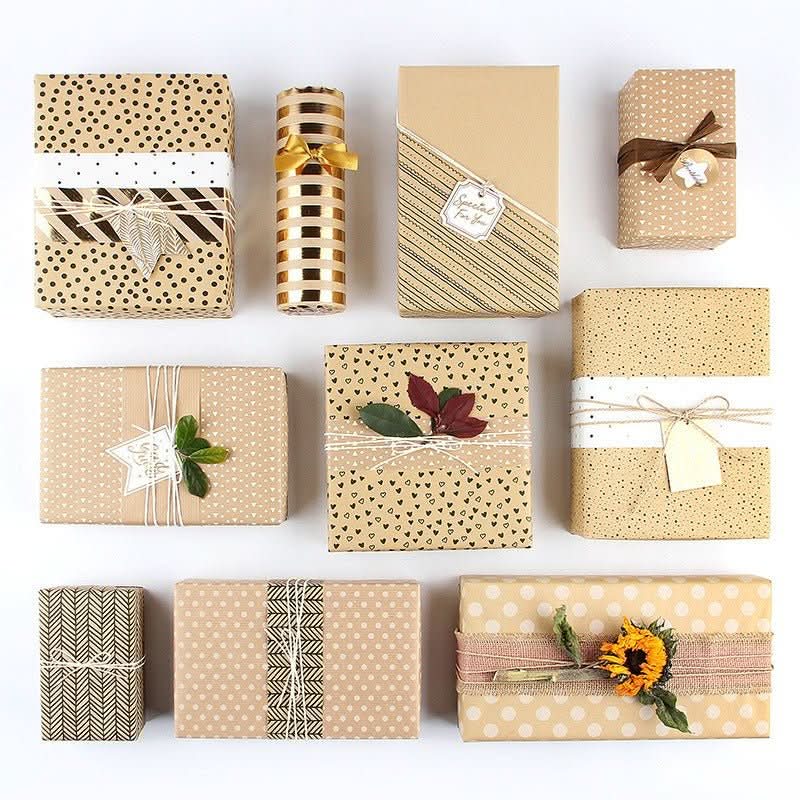 Various patterns of gift paper, including polka dots, hearts, and stripes, with ribbons and natural embellishments.