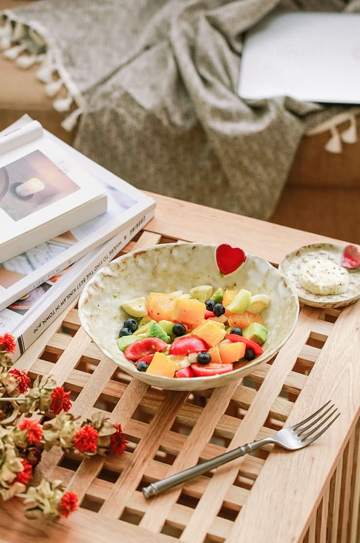 Handcrafted Japanese Love Ceramic Dinner Plate with fruit salad, on a wooden table.