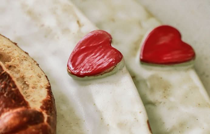 Handcrafted Japanese Love Ceramic Dinner Plate: White plate with red heart accents and bread slice.
