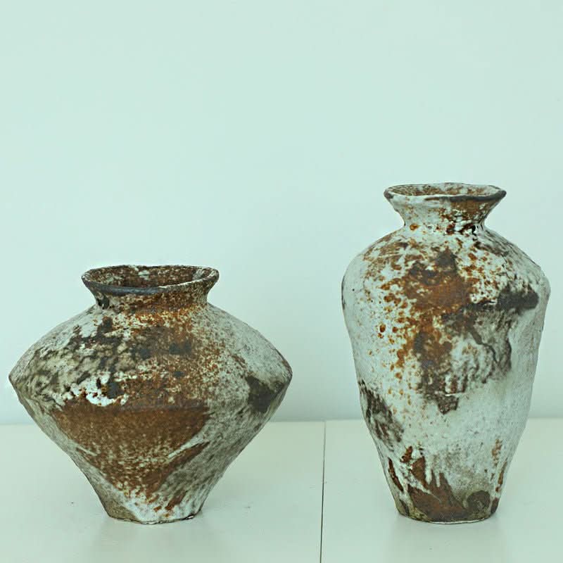 Handmade ceramic vase with rugged, wabi-sabi texture in white and brown, perfect for zen decor.