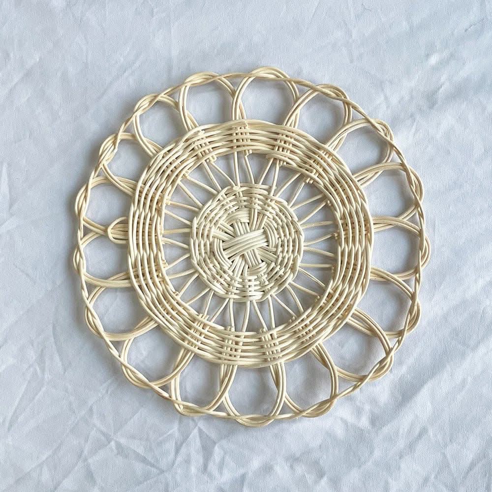 Handmade natural rattan wall hanging decor with intricate woven pattern on white background.