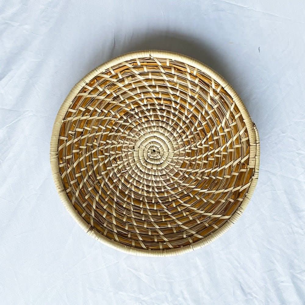 Natural Rattan Wall Hanging Handmade Set. Woven round basket with spiral pattern on white background.