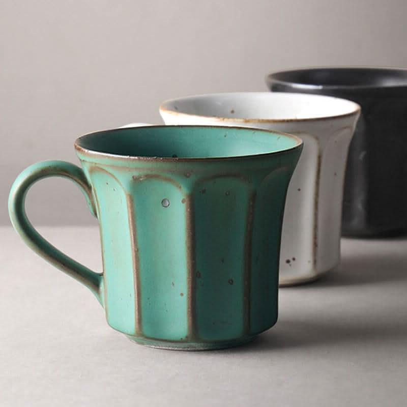 Turquoise handmade stoneware coffee mug with vertical pattern, speckled finish.
