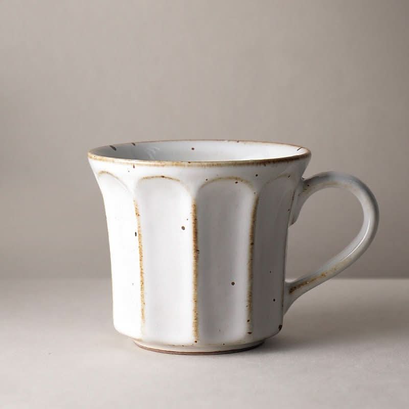 White speckled stoneware coffee mug with vertical pattern, Nordic, Japanese, rustic style.