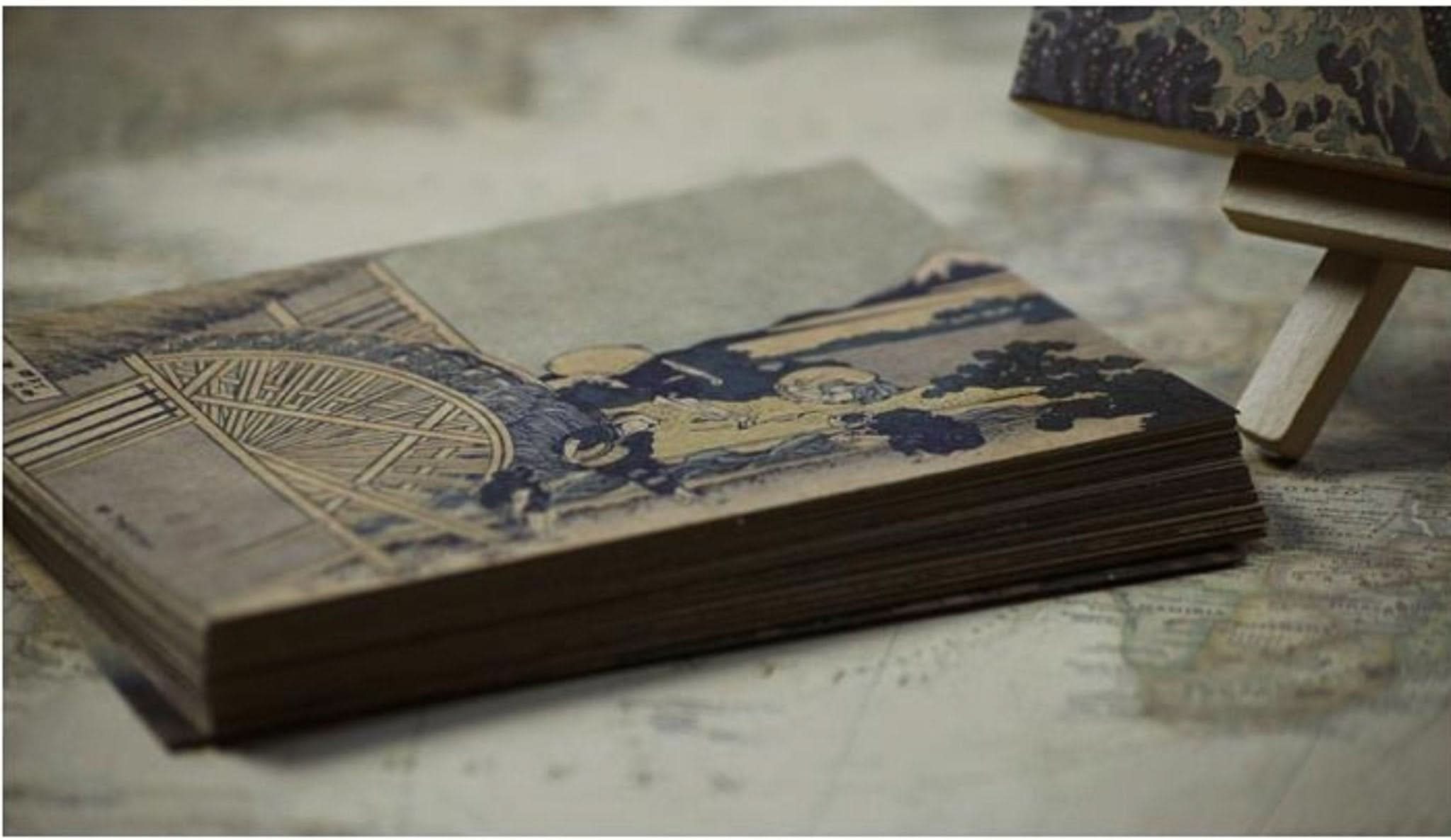 Hokusai Japanese Art Postcards feature traditional ukiyo-e prints in sepia tones on aged paper.