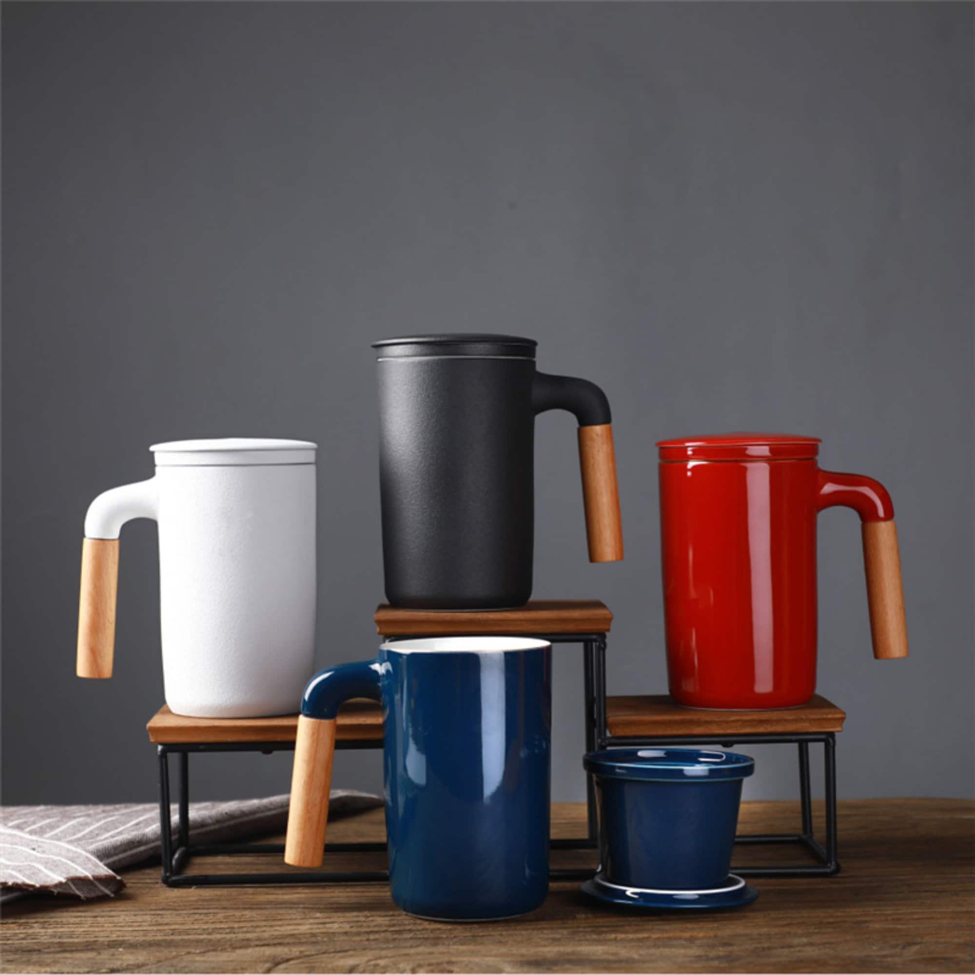 Japanese Mug 2x1 Ceramic With Lid and Strainer: White, black, red, blue mugs with wooden handles.