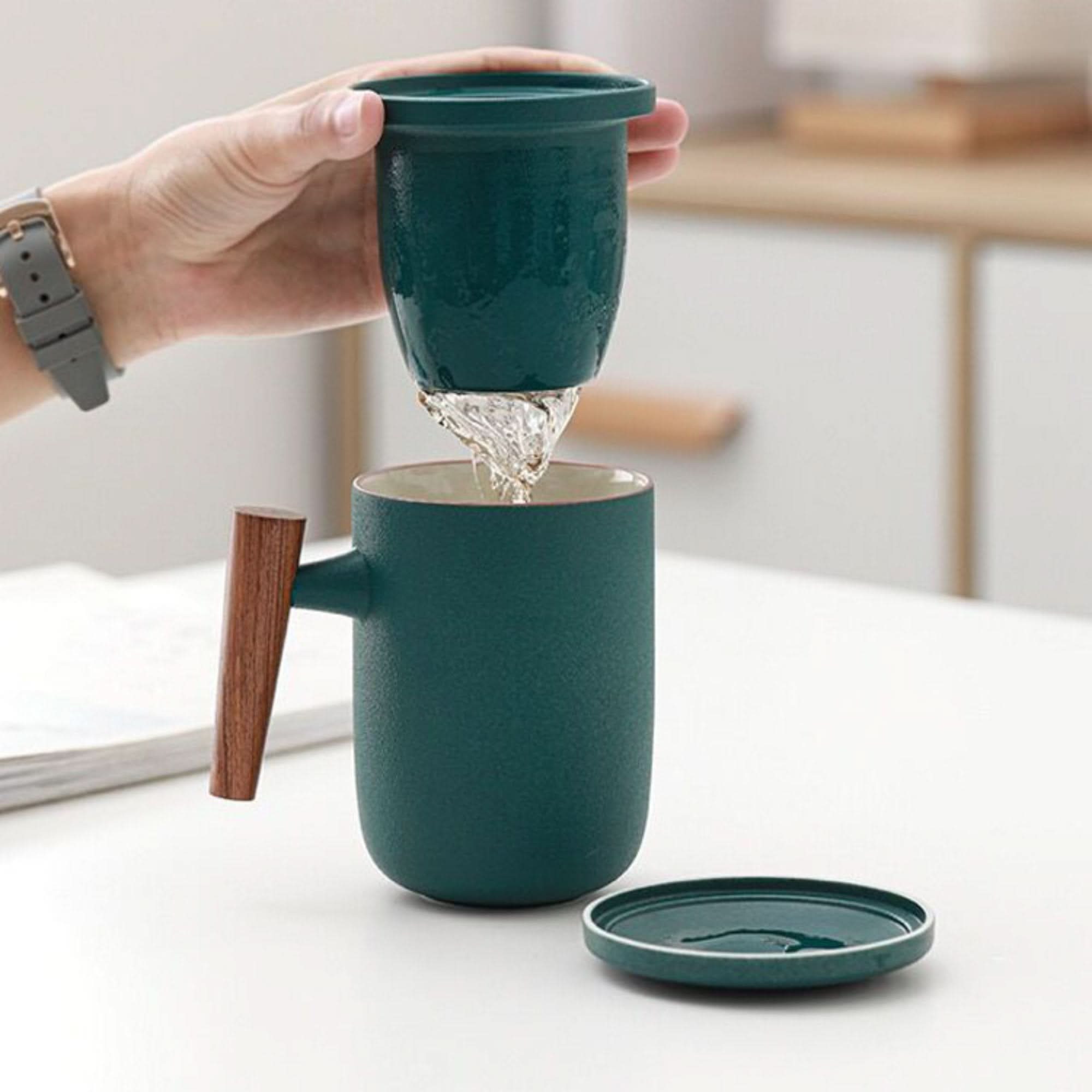 Teal Minimalist Japanese Mug 13.5oz with wooden handle, preparing tea.