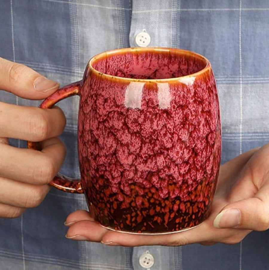Hands holding a red reactive glazed Vintage Pottery Mug, 13.5oz, large coffee mug.